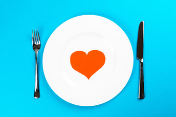 white plate with blue background and red hearts for valentines dinner