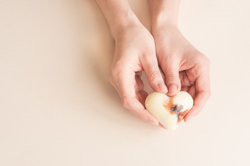 Beautiful groomed woman's hands with body and skin oil on a light background. Nourishing oil for skin in winter time.