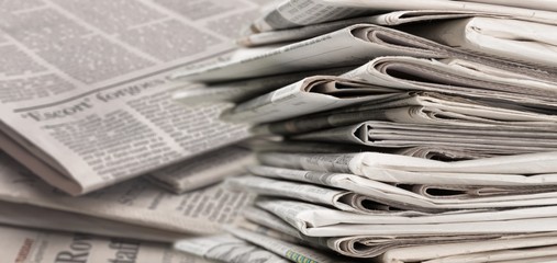 Pile of newspapers on white background