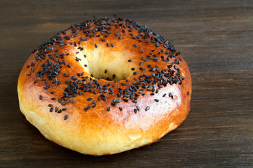 Bagels with seeds on a black background.