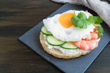 egg and cucumber sandwich on wooden background.