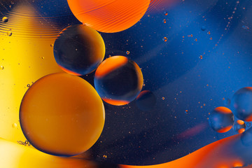 Colorful oil bubbles in water. Space, biology, phycics or chymistry abstract background.