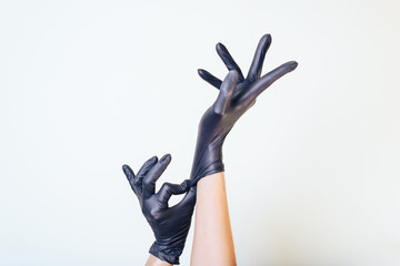 Fototapeta premium black latex gloves are stretched on hands.