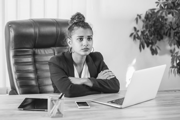 Young business lady dressed in business clothes is in the office. During this time, he put a hand...