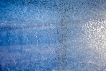 winter patterns on glass. Ornate frost pattern on frosted window as Christmas background