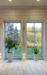 Bright photo studio interior with big window, high ceiling, white wooden floor