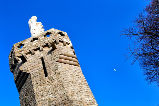 Tower and white statue on Mont Dol in Brittany, France.