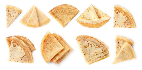 Set of folded tasty thin pancakes on white background, top view