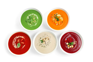 Various soups in bowls on white background, top view. Healthy food