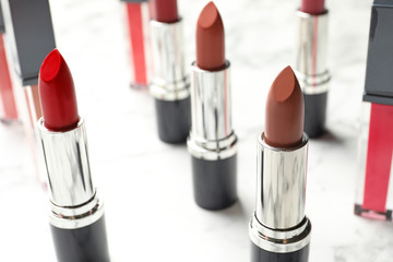 Different lipsticks on light background. Cosmetic product