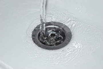 Stream of water flowing to the sink, background