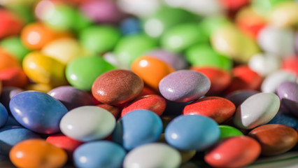 Colorful candy, bright background of round candies in the glaze