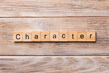 CHARACTER word written on wood block. CHARACTER text on wooden table for your desing, concept