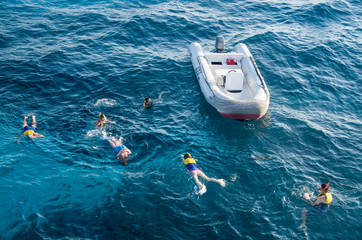 Swimmers and rescue inflatable boat in sea in Hurgada