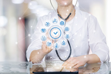 A doctor with a circle of medical symbols icons and quality sign.
