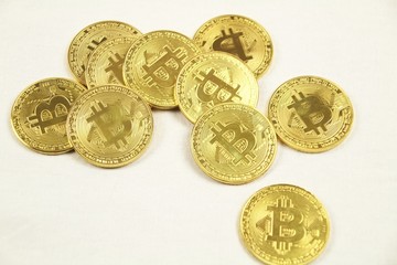 Golden bitcoins on white background