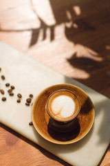 Coffee served with coffee beans, concept of happy cheerful morning, bright sun is shining, vertical image