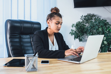 Young beautiful business lady dressed in a business stylish black jacket.