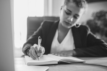 Young pretty smart business girl works in the office. During this, it creates important steps for...