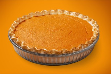 Home made pumpkin pie on white background.