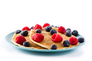 Pancakes with raspberries and blueberries isolated on white background