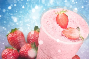 Glass of strawberry smoothie on wooden table