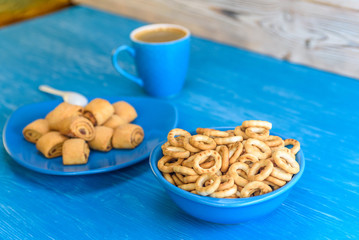 Cookies rolls with jam on a wooden turquoise background.