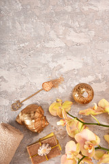 Golden spa concept with orchid, shells, sea salt. Top view.