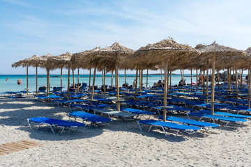 Fototapeta na wymiar straw sun umbrellas on Elafonisi beach in Crete