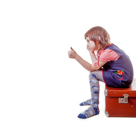 I am happy to travel, I am ready for the trip! Portrait of funny and happy little child girl with vintage suitcase.