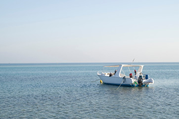 Naklejka na ściany i meble Anchored boat in the sea in Hurgada