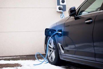 Hybrid car charging in parking. Electric car charging. Eco-friendly transport