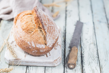 Freshly baked homemade traditional bread on rustic wooden table