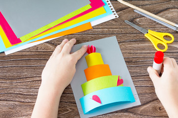 The child glue Greeting card with birthday cake congratulation. Children's art project craft for...