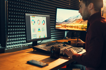 Male Videographer Edits and Cuts Footage and Sound on His Personal Computer