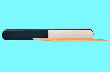 Nail file and nail sticks on blue background