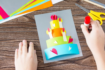 The child glue Greeting card with birthday cake congratulation. Children's art project craft for...