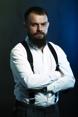 close up portrait , model, man, young handsome man with big beard on black yellow and blue background 