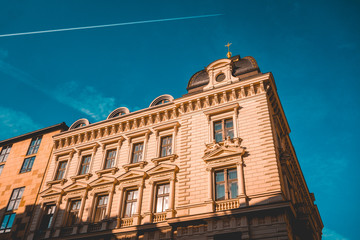 Fototapeta na wymiar Stone facade with architraves of historic building