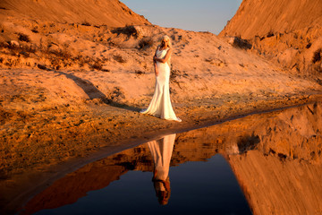beautiful girl in a white dress on the river bank