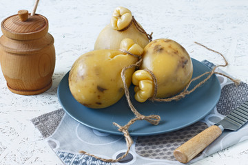 Cheese Caciocavallo with honey on a plate on a white background. Cheese pear