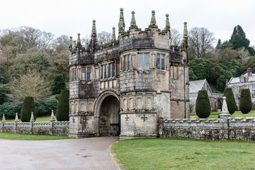 Obraz premium historic, ancient entrance with a fence in an old manor and park around the buildings