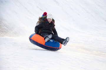 .Child sledding cheesecake.Sledding off a snow slide
