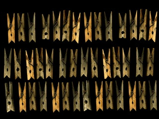 Old wooden clothespins on a black background. Vintage wooden clothespins.