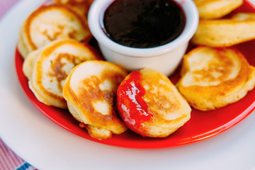 Tasty baked pancakes with strawberry jam