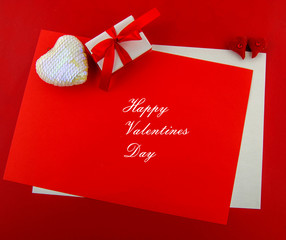 Valentine day concept. Red letter paper with decorative hearts and a gift box with a greeting card...