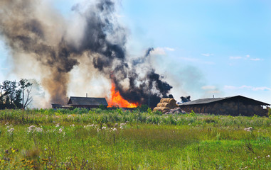Fototapeta na wymiar flaming rustic hay warehouses