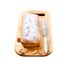 Banana cake with walnuts and dark chocolate on wooden board isolated on white background with clipping path