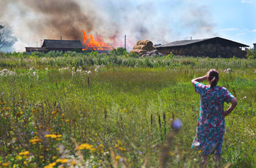 woman looks in summer on fire