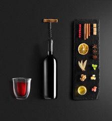 Mulled wine recipe ingredients and kitchen accessories, bottle of red wine, cinnamon, anise stars,...